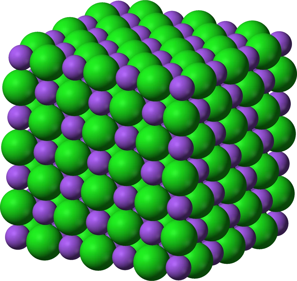 3D ball-and-stick model of the sodium chloride ionic lattice, showing the cubic arrangement of alternating Na⁺ and Cl⁻ ions
